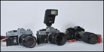 A collection of 20th Century film cameras with lenses to include a Praktica MTL 5B camera with a
