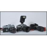 A collection of 20th Century film cameras with lenses to include a Praktica MTL 5B camera with a