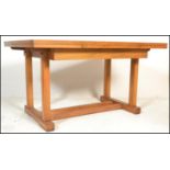 A mid 20th century solid oak Arts & Crafts revival large Air Ministry oak refectory draw leaf dining