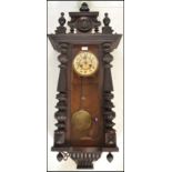 A 19th Century Vienna regulator pendulum wall clock being mahogany cased with turned knopped columns