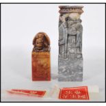 Two 20th Century Chinese carved soapstone cylinder desk seals of rectangular form, one carved into