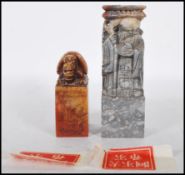 Two 20th Century Chinese carved soapstone cylinder desk seals of rectangular form, one carved into