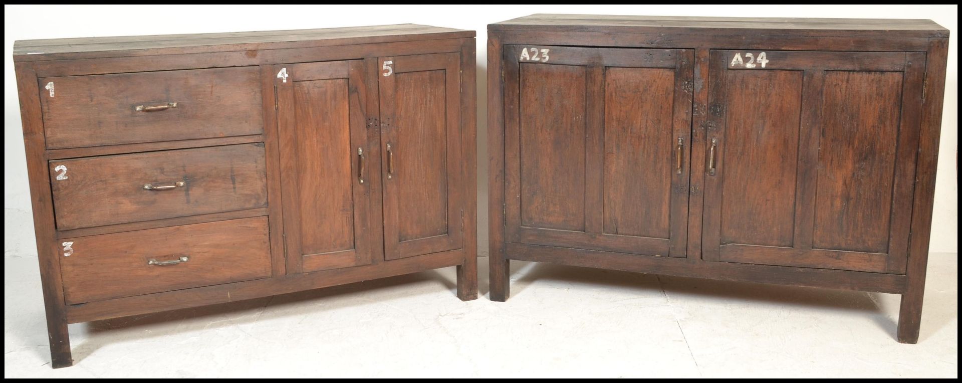 A pair of unusual 20th century hardwood sideboard cabinets of hardwood construction being raised