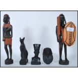 Two 20th Century African carved wood tribal figurines in the form of a warrior holding a spear and