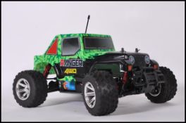 A contemporary Ranger 4WD remote control car complete with shell and the engine components etc