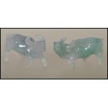 A pair of Chinese jade carved figurines of small proportions in the form of water buffalos. One of