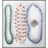 A group of three 20th Century beaded necklaces to include a malachite beaded necklace, a white glass