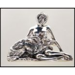 A stamped sterling silver brooch pendant in the manor of Georg Jensen depicting a nude lady