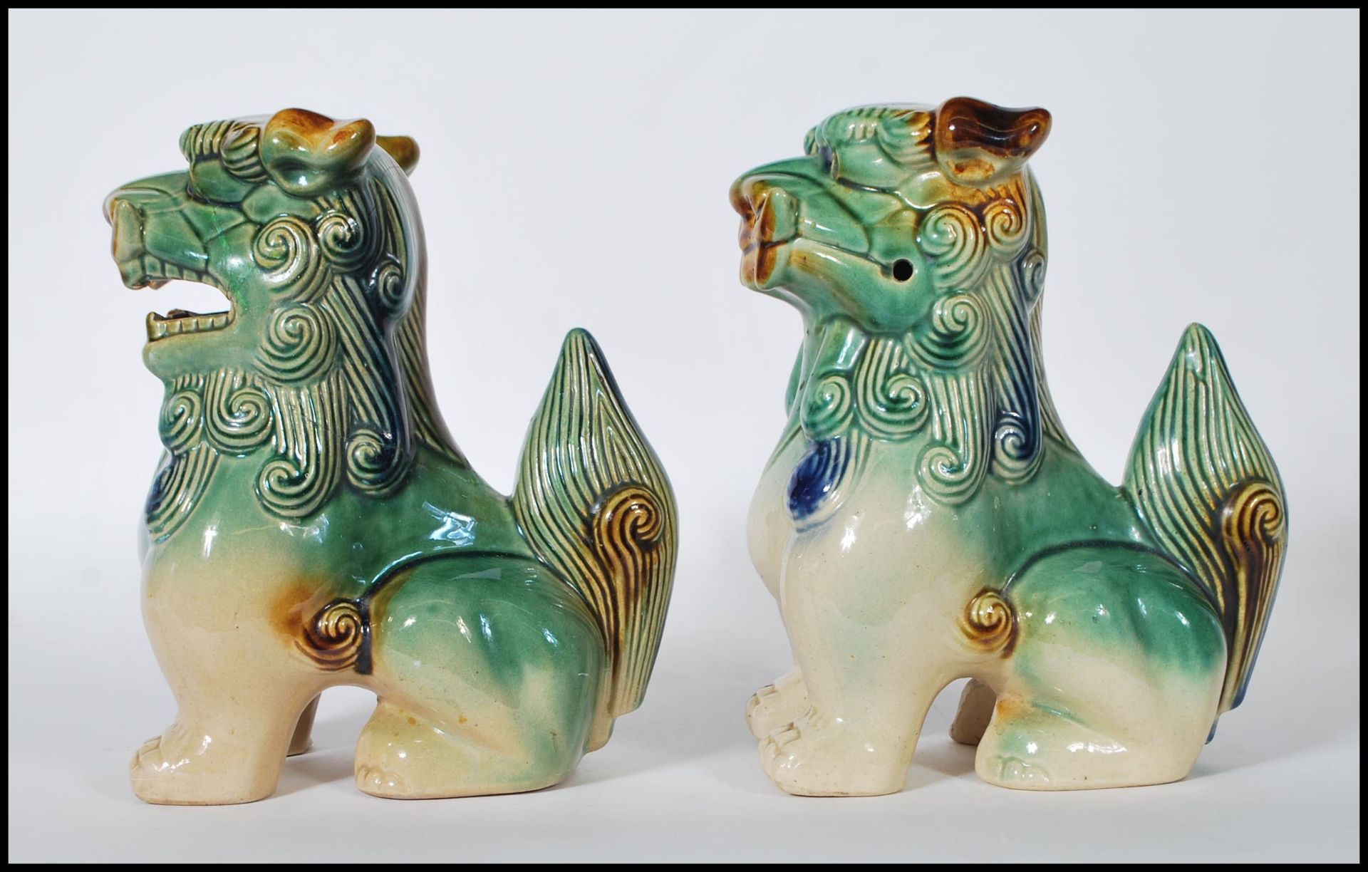 A pair of mid 20th Century Chinese porcelain temple lions / dogs of  Fu. Both modeled with a jade - Image 4 of 6