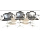 A set of 6 mid century retro chrome and faux black leather swivel chairs - dining chairs having been