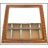 A 20th century giltwood and gesso framed rectangular overmantle wall mirror of square form,