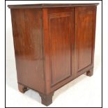 A 19th century Georgian mahogany cupboard / bookcase cabinet. Raised on bracket feet with twin