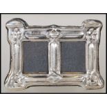 A silver hallmarked Art Nouveau style easel back double photo frame of rectangular form.