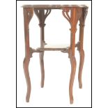 An early 20th Century Edwardian Arts and Crafts style mahogany two tier occasional centre table, the