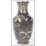 A 20th Century Chinese cloisonne baluster vase having a black ground with blue and yellow floral