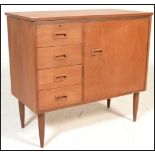 A 1970's retro teak wood singer sewing machine cabinet with fold over top and cabinet raised on