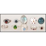 A selection of silver ladies dress rings to include an abalone shell set ring, a ring set with an