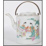 A 19th Century Chinese ceramic teapot of cylindrical form being hand painted with a domestic scene