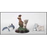 A Royal Copenhagen figurine in the form of a grey and white cat no. 727 together with a LLadro style