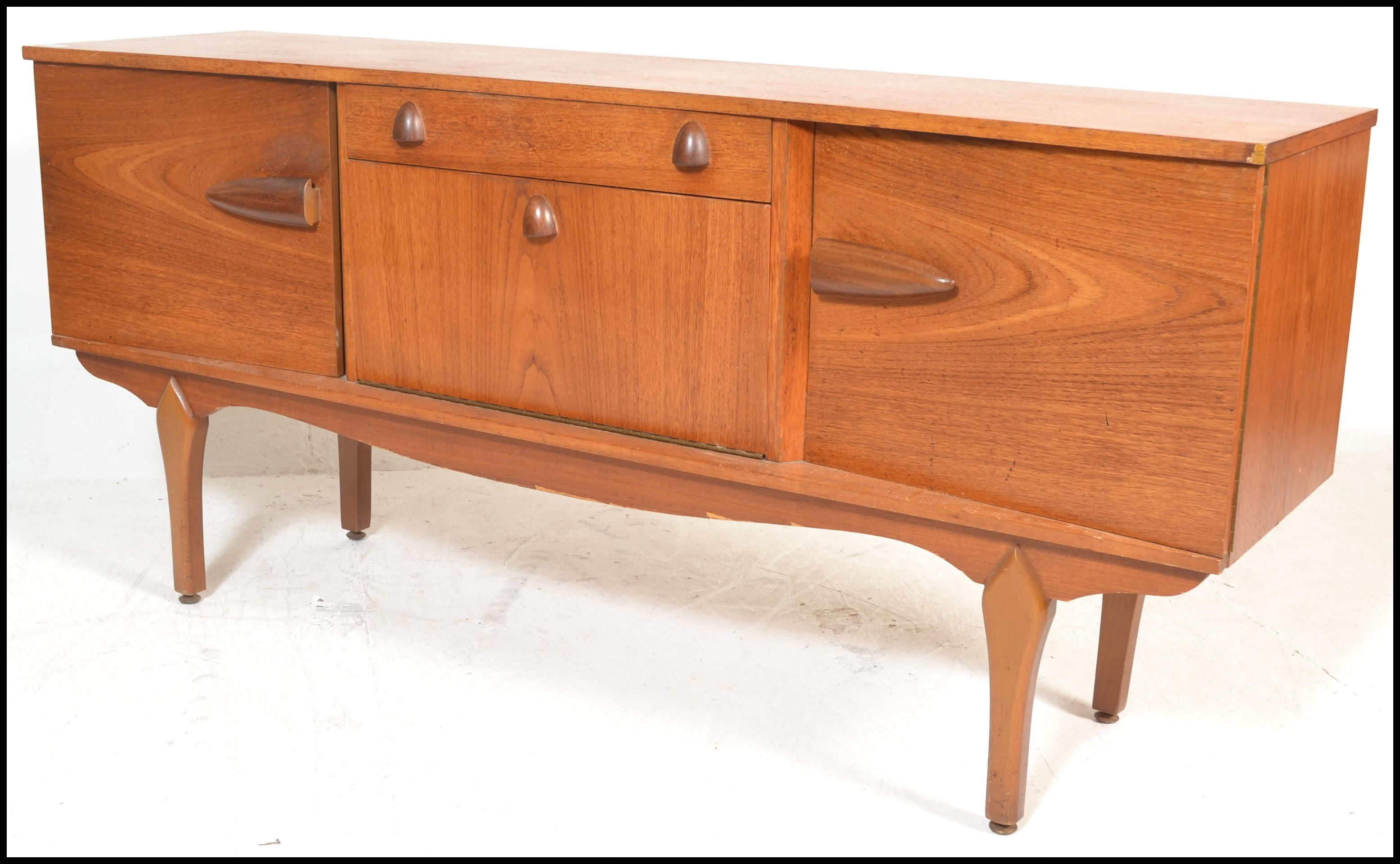 A vintage mid 20th century teak wood sideboard having a central drop down bar compartment with - Image 3 of 6