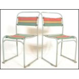 A pair of vintage mid 20th Century metal tubular village hall dispersal chairs, upholstered with a