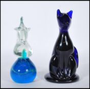 A Mdina studio glass paperweight in the form of a horse, the base having a blue and green swirl