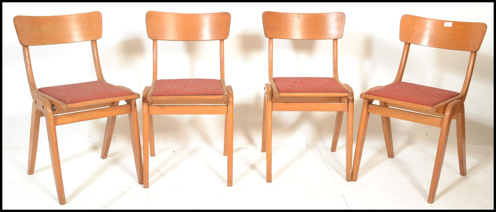 A set of 4 mid century stacking dining chairs in the manner of Ben Chairs. Beechwood bentwood a-