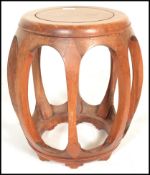 A 20th Century Chinese hardwood garden seat / opium stool of simple open barrel form having