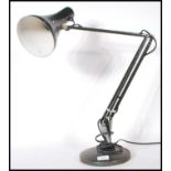 A vintage 20th Century Herbert Terry anglepoise desk lamp having a pendant shade on an adjustable