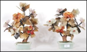 A pair of large Chinese jade and hardstone Ming trees each modelled with peony flowers and raised in