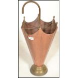A 20th Century Arts and Crafts antique style hammered copper umbrella stand in the form of an