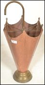 A 20th Century Arts and Crafts antique style hammered copper umbrella stand in the form of an
