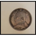 A Republic of China year 10 silver dollar having Yuan Shikai facing left. Weight 27.5g. Measures 4cm