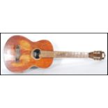 A 20th Century Columbia Junior six string acoustic guitar having a rustic varnished body with