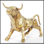A 20th century cast bronze figurine in the form of a standing bull having a gilt exterior.