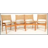 A set of four mid 20th century 1960's Danish dining chairs having teak frames with pad upholstered