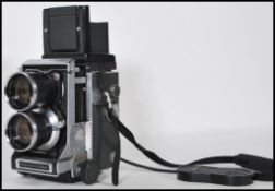 A Mamiya C33 Professional twin lens reflex camera complete with the Mamiya Sekor Lens with cover
