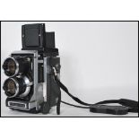 A Mamiya C33 Professional twin lens reflex camera complete with the Mamiya Sekor Lens with cover