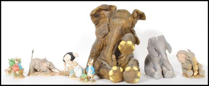 A collection of composite figures to include Peter Rabbit figures x four, four x elephant figures