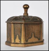 A 19th Century cast bronze tea / tobacco press of octagonal form having embossed panelled decoration