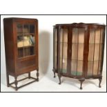 A 1930's mahogany Queen Anne revival bow fronted china display cabinet with twin opening doors