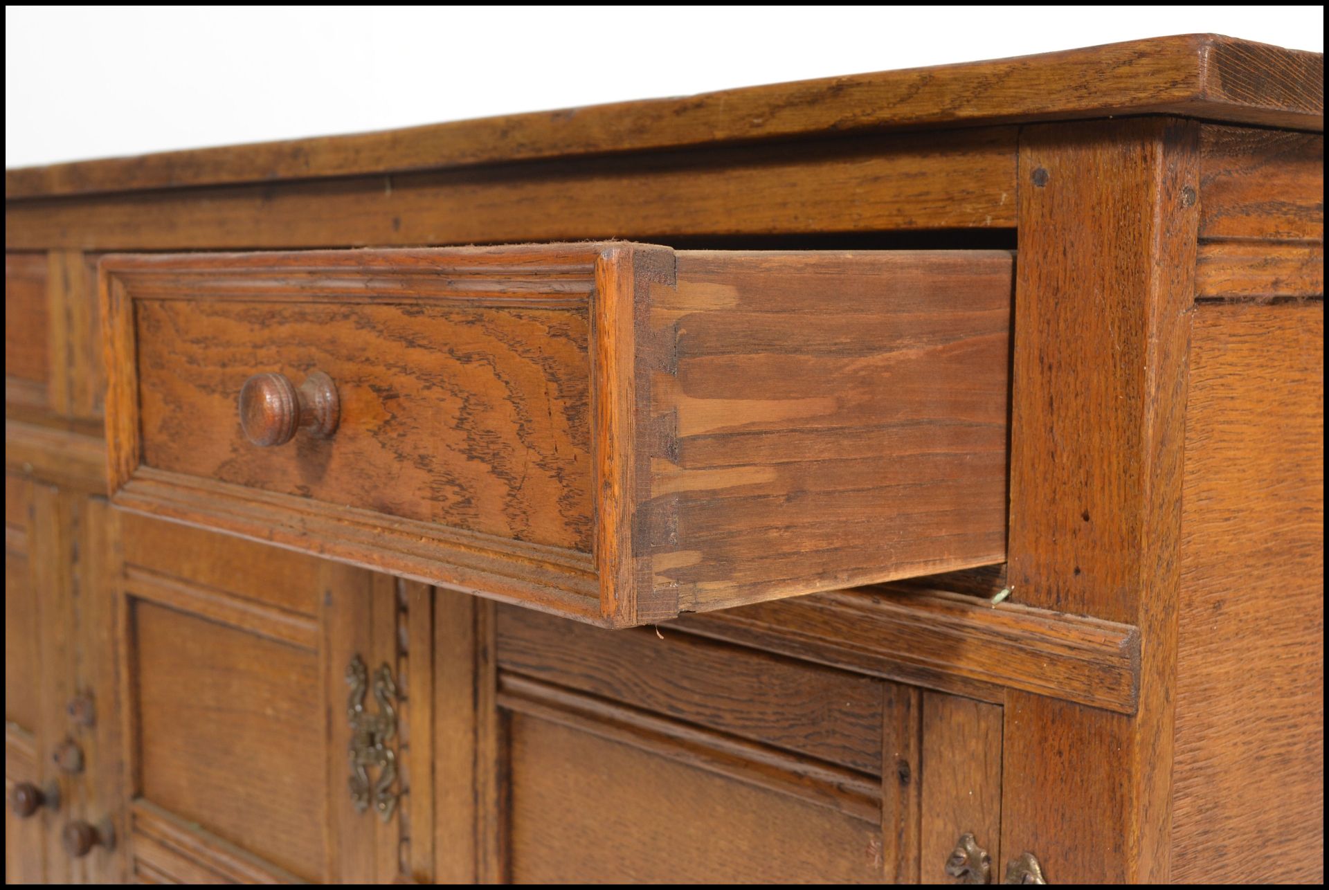 A 20th Century oak Jacobean revival sideboard credenza, flared top over a configuration of drawers - Image 4 of 6