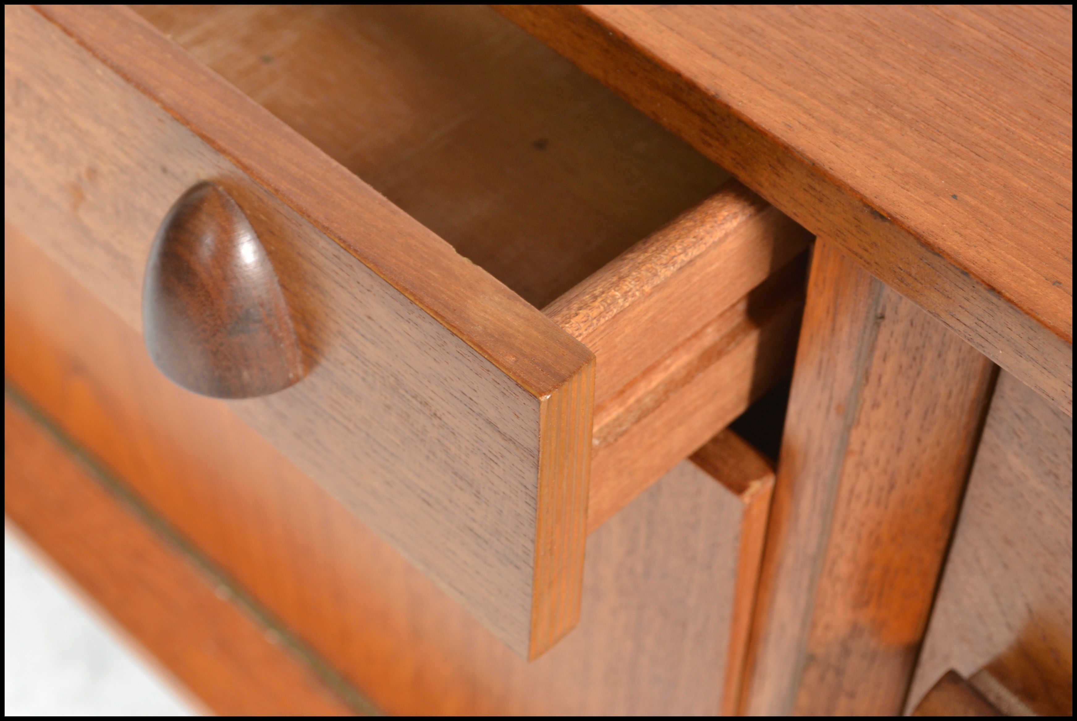 A vintage mid 20th century teak wood sideboard having a central drop down bar compartment with - Image 4 of 6