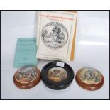 A group of three Staffordshire Prattware pot lids to include 'The Village Wedding', 'The Wolf and