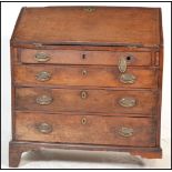 A Georgian 19th century mahogany bureau desk. Raised on bracket feet with a bank of drawers having