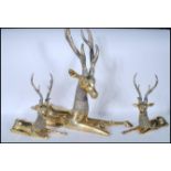 A large 20th Century brass figural six point stag / deer, modelled in the seated position together