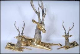 A large 20th Century brass figural six point stag / deer, modelled in the seated position together