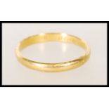 A hallmarked 22ct gold wedding band ring of typical form. Hallmarked London 1941. Weight 2.5g.