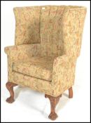 A 20th Century contemporary Georgian revival mahogany framed wingback open armchair, scalloped