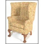 A 20th Century contemporary Georgian revival mahogany framed wingback open armchair, scalloped